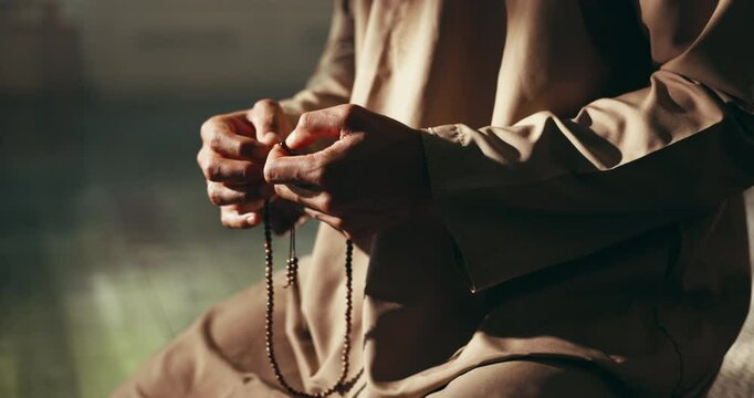 Home, prayer and hands of Muslim man with beads for religious belief, worship and praise to Allah. Religion, spiritual and person with misbaha for praying, salaah and fasting for Ramadan Kareem