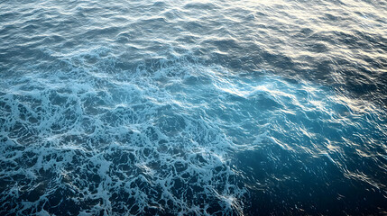 Fototapeta premium Deep Blue Ocean Waves With White Foam And Sunlight Sparkle On The Surface Creating A Tranquil And Serene Seascape