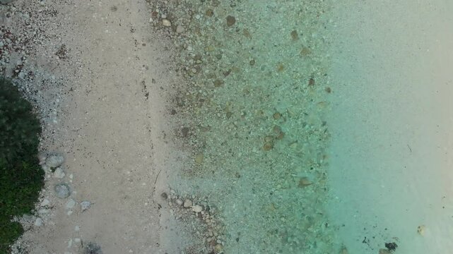 Drone lifts from Soča River near Trenta, soaring above crystal-clear water and trees