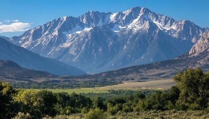 Obraz premium Majestic Snowcapped Mountains Overlooking Verdant Valley