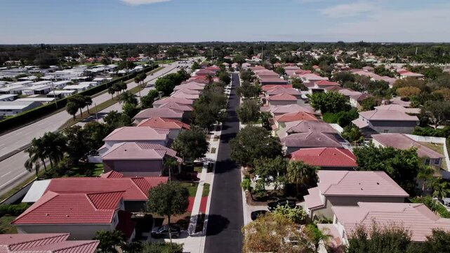 Aerial: West Palm Beach residential zone during the day, pan tilt up drone shot, USA