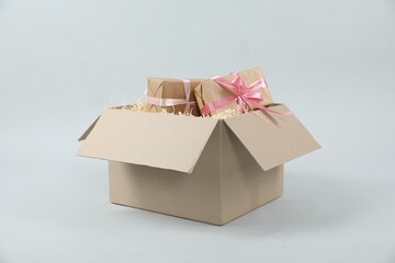 Parcel with gift boxes on light background