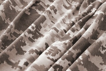 Texture of Dark green pixel camouflage military uniform textile cloth with folds