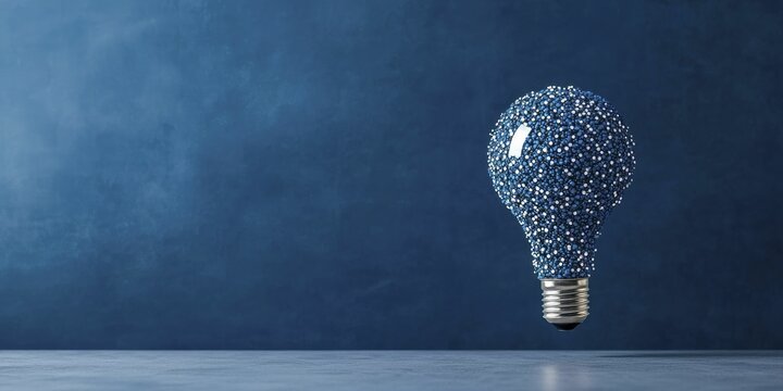 A flowing ribbon entwined with a light bulb, representing fresh ideas and imaginative approaches in gamification for distributed teams.