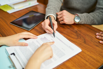Businessman signing contract with help from financial advisor
