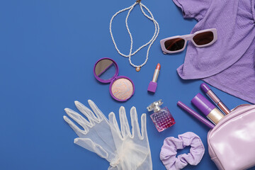 Composition with sunglasses, perfume, cosmetics and accessories on blue background. Closeup