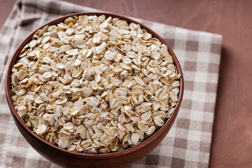 Bowl of Oat Flakes on Linen Napkin, Close-Up