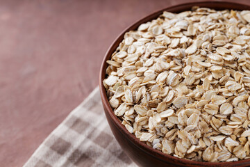 Bowl of Oat Flakes on Linen Napkin, Close-Up