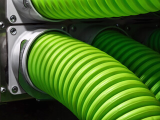 Bright green hoses attached to machinery in an industrial setting showing intricate details and...