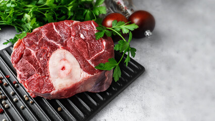 Fresh beef osabuko with brightly coloured herbs in a rustic kitchen interior for culinary inspiration