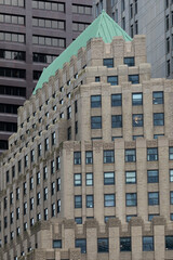 Historic and modern buildings in downtown Boston featuring intricate facades, brickwork, and Art Deco details. The urban architecture highlights the city's rich architectural heritage and design style