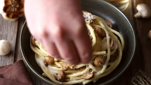 Bucatini pasta in creamy sauce with mushrooms and cheese. Vegetarian food. Italian cuisine.