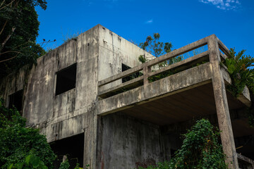 Beautiful abandoned building on the seashore. Sunny beach. Beautiful sea. Concrete walls.