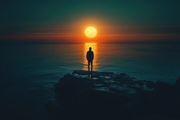 Solitary figure on coastal rock at sunrise