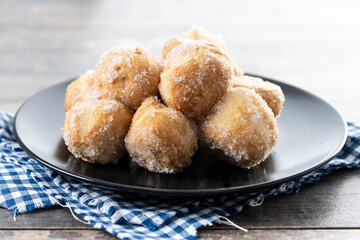 Traditional Carnival fritters or buñuelos de viento on wooden table