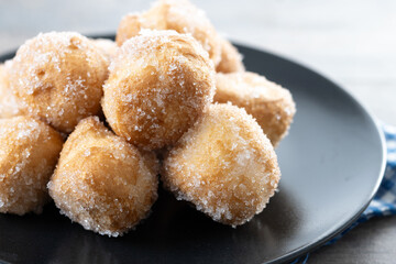Traditional Carnival fritters or buñuelos de viento on wooden table. Close up