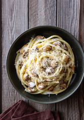 Bucatini pasta in creamy sauce with mushrooms and cheese. Vegetarian food. Italian cuisine.