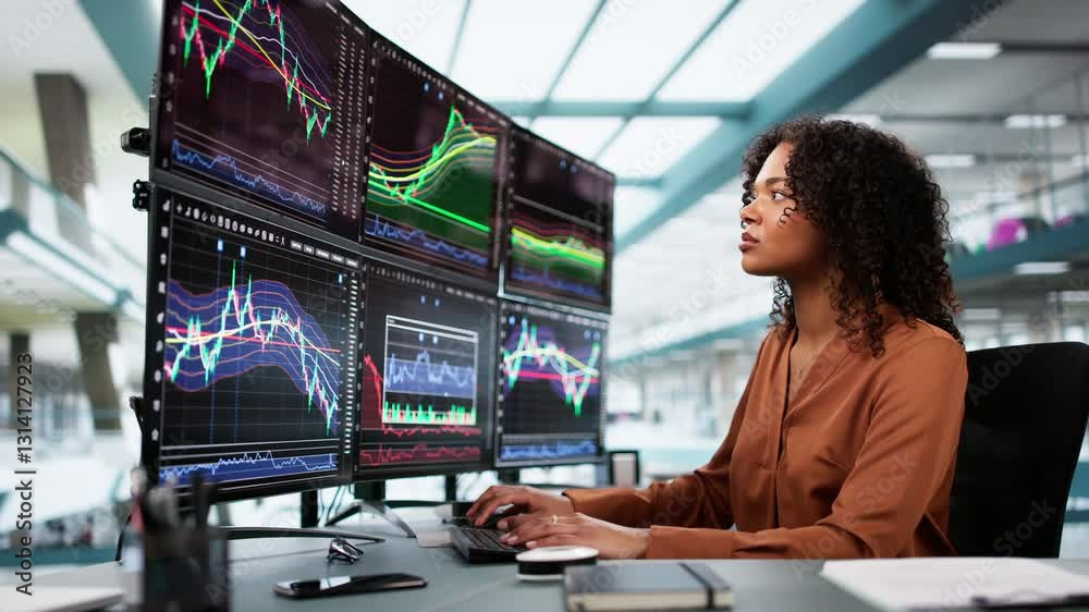 Poster stock market broker looking at graphs on multiple screens