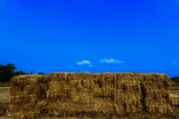A scenic view of a haystack under a clear sky, representing rural life, agriculture, and the harvest season. The image showcases the simplicity and beauty of countryside landscapes.