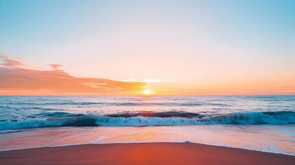 Obraz premium Vivid Coastal Sunset Over a Sandy Beach with Gentle Waves in Orange Pink and Blue Hues
