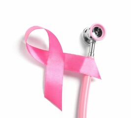 Breast cancer awareness. Pink ribbon and stethoscope isolated on white, top view