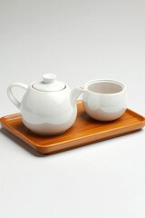 White ceramic tea set on wooden tray