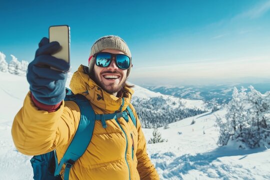 Young man taking selfie picture with smart cell phone hiking mountain on snowy slope - Happy skier having fun in ski resort vacation - Winter lifestyle, extreme sport and happy people - Powered by Adobe