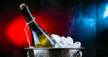 Bottle of wine in bucket with crushed ice