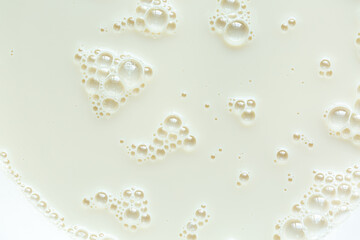 Macro milk texture,macro milk background,White surface of milk and bubbles and ripples from above birds eye view