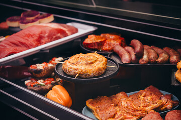 Different kinds of meat and sausages on sale at a local market or butchery.