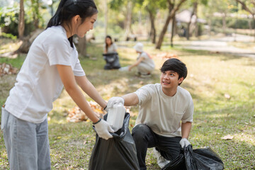 Young volunteers working together to clean up the park, promoting sustainability and teamwork.