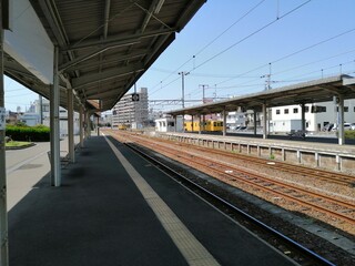 It says "Ube Shinkawa Station" in Japanese. Ube Shinkawa Station in Yamaguchi Prefecture, Japan is the station that appeared in the last scene of the movie "Evangelion: 3.0". It means that Evangelion 