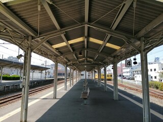 It says "Ube Shinkawa Station" in Japanese. Ube Shinkawa Station in Yamaguchi Prefecture, Japan is the station that appeared in the last scene of the movie "Evangelion: 3.0". It means that Evangelion 