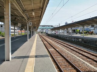 It says "Ube Shinkawa Station" in Japanese. Ube Shinkawa Station in Yamaguchi Prefecture, Japan is the station that appeared in the last scene of the movie "Evangelion: 3.0". It means that Evangelion 