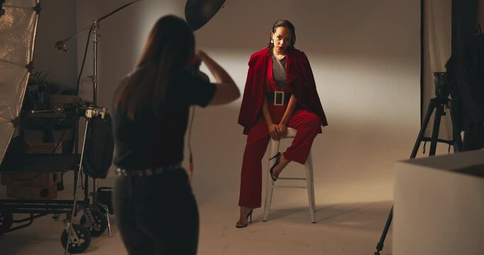 Photographer, fashion and model with people in studio for production, backstage and magazine campaign. Photoshoot, behind the scenes and creative director with women on set for branding process