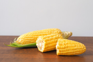 Fresh corn on wooden table background