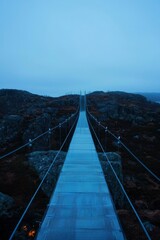 Obraz premium Misty mountain suspension bridge