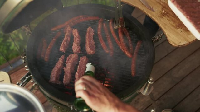 Chef grilling sausages and ćevapi on barbecue