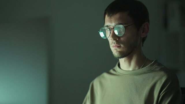 Focused facial close-up of a male designer, engrossed in technology-driven project research and network analysis.