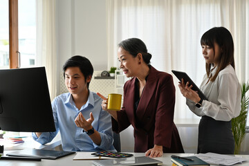 Creative Team Collaboration with Senior Leadership, discussing ideas at a modern workspace