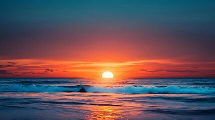 Obraz premium Vivid Coastal Sunset Over a Tranquil Ocean with Gentle Waves and Colorful Sky Reflecting on the Water