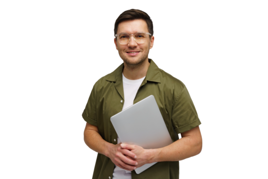 Young man smiling while holding a laptop in a studio setting during a bright morning session