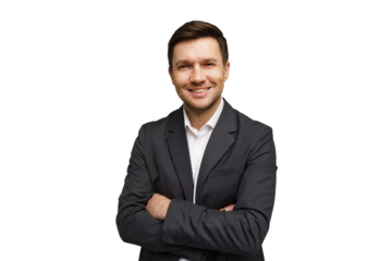 Smiling young man in a suit with arms crossed against a plain background