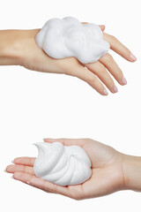 Female hand holding white, soap suds, on a white isolated background. Hands with white bubbles. Copy space. Background, splash. AI generated