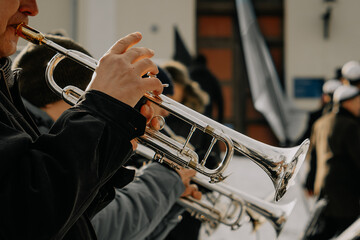 Talented musicians perform an elegant outdoor brass concert, playing French horns with skill and...