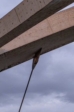 Concrete structure with steel cable detail against cloudy sky, Zaragoza, Spain.
