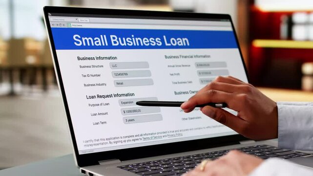 Person Hand Over Small Business Loan Application