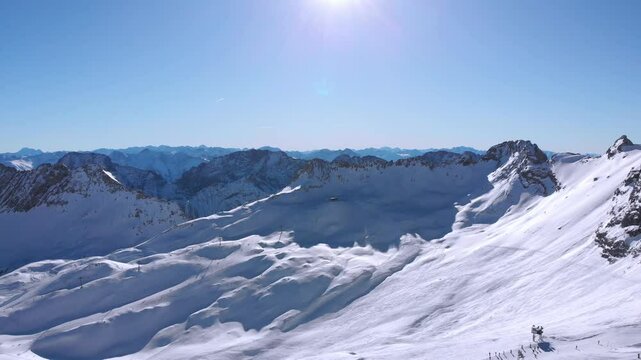 Wetterstein Mountains in a sunny day with some skiers in the background in the Zugspitze ski area