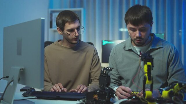 IT professionals engaged in coding conversations, showcasing creativity in a sleek office."