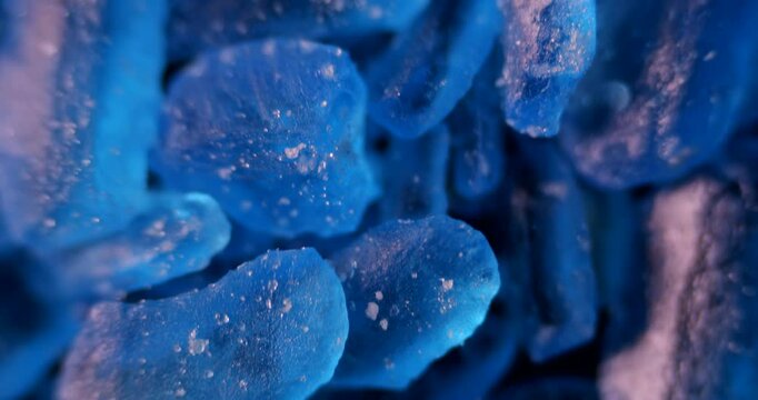 Vibrant blue CuSO4 crystals with perfect geometric patterns under microscope. Ideal for educational and artistic applications.